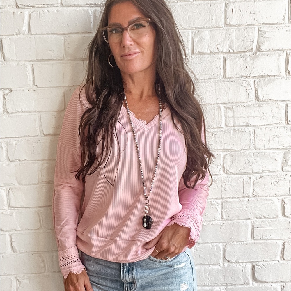 Soft pink v-neck top with lace details